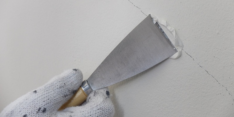 Application d'un enduit de lissage sur une fissure