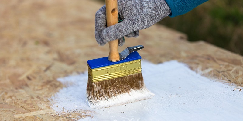 Application de peinture au pinceau sur planche osb